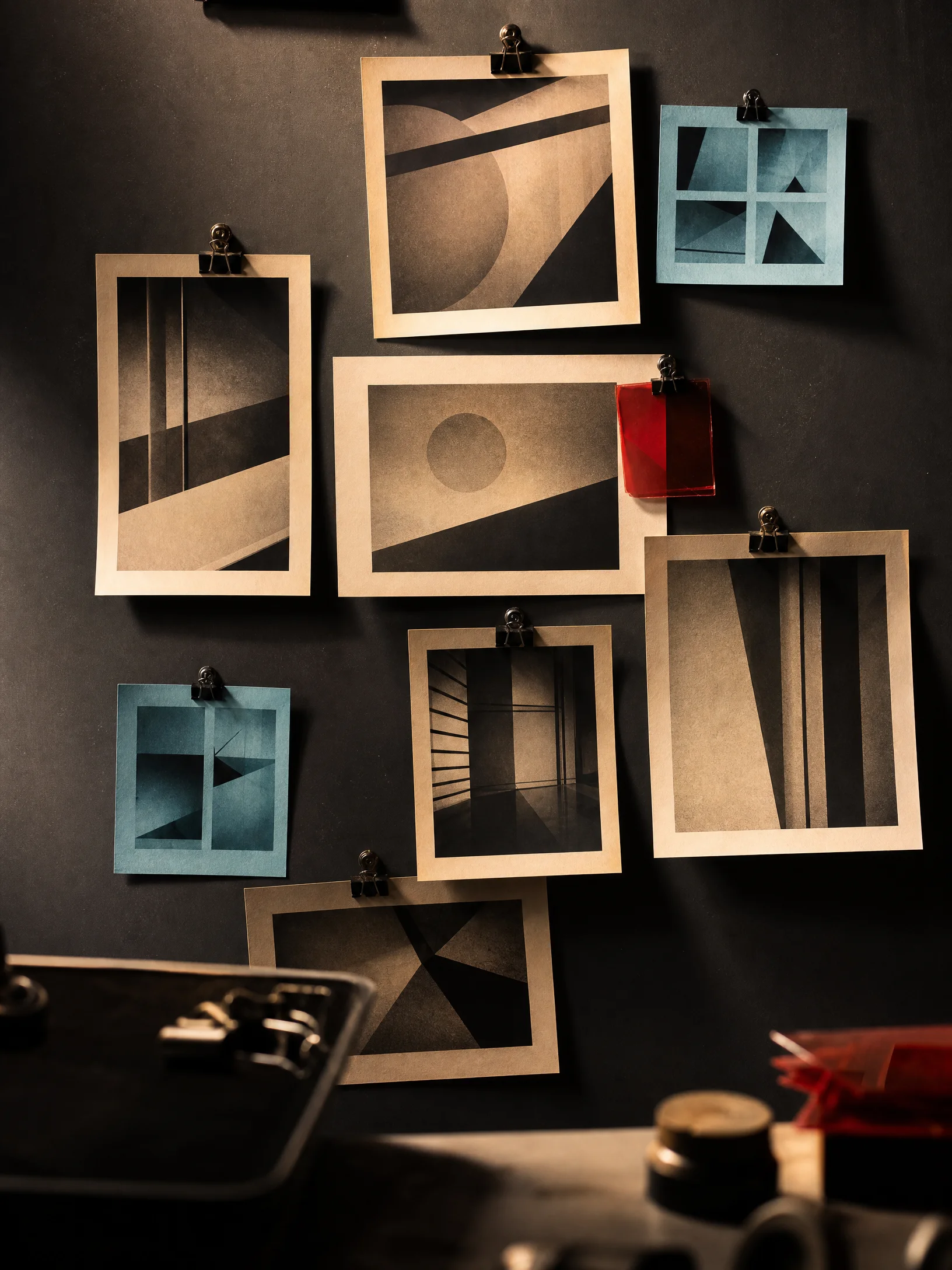Dark proof wall with photographic frames pinned for comparison